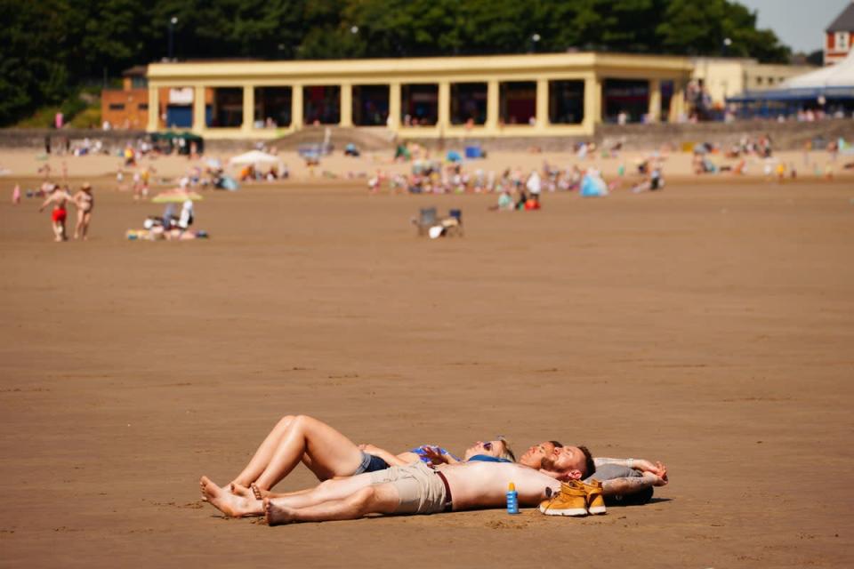 People enjoy the sunshine at Barry Island, Wales (Ben Birchall/PA) (PA Wire)