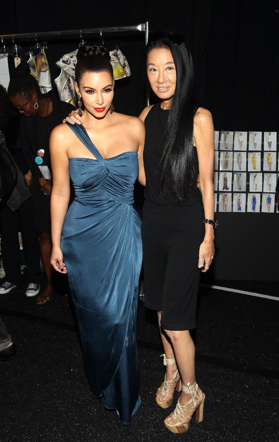 FILE - This Sept. 13, 2011 file photo shows TV Personality Kim Kardashian, left, posing with fashion designer Vera Wang backstage at the Vera Wang 2012 Spring collection during Mercedes Benz Fashion Week in New York. Wang, 63, was honored for her lifetime achievement by the Council of Fashion Designers at its star-studded awards show Monday night. She received the award from her former employer and mentor Ralph Lauren, and she received a standing ovation from her peers. (AP Photo/Donald Traill, file)