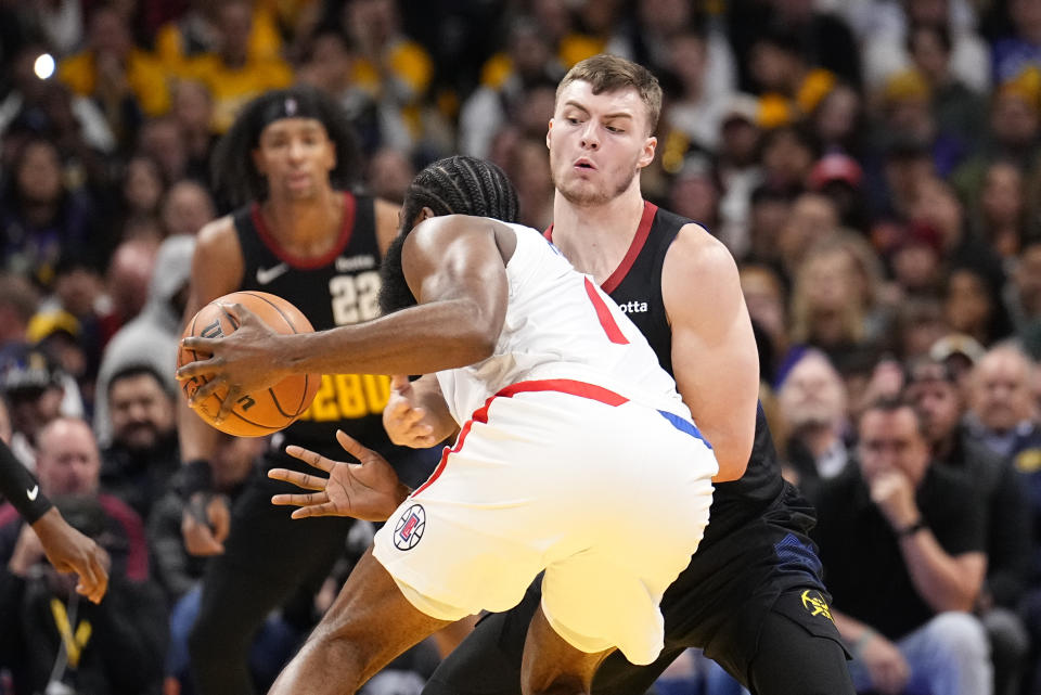 Denver Nuggets guard Christian Braun fouls Los Angeles Clippers guard James Harden (1) during the first half of an NBA basketball in-season tournament game Tuesday, Nov. 14, 2023, in Denver. (AP Photo/Jack Dempsey)