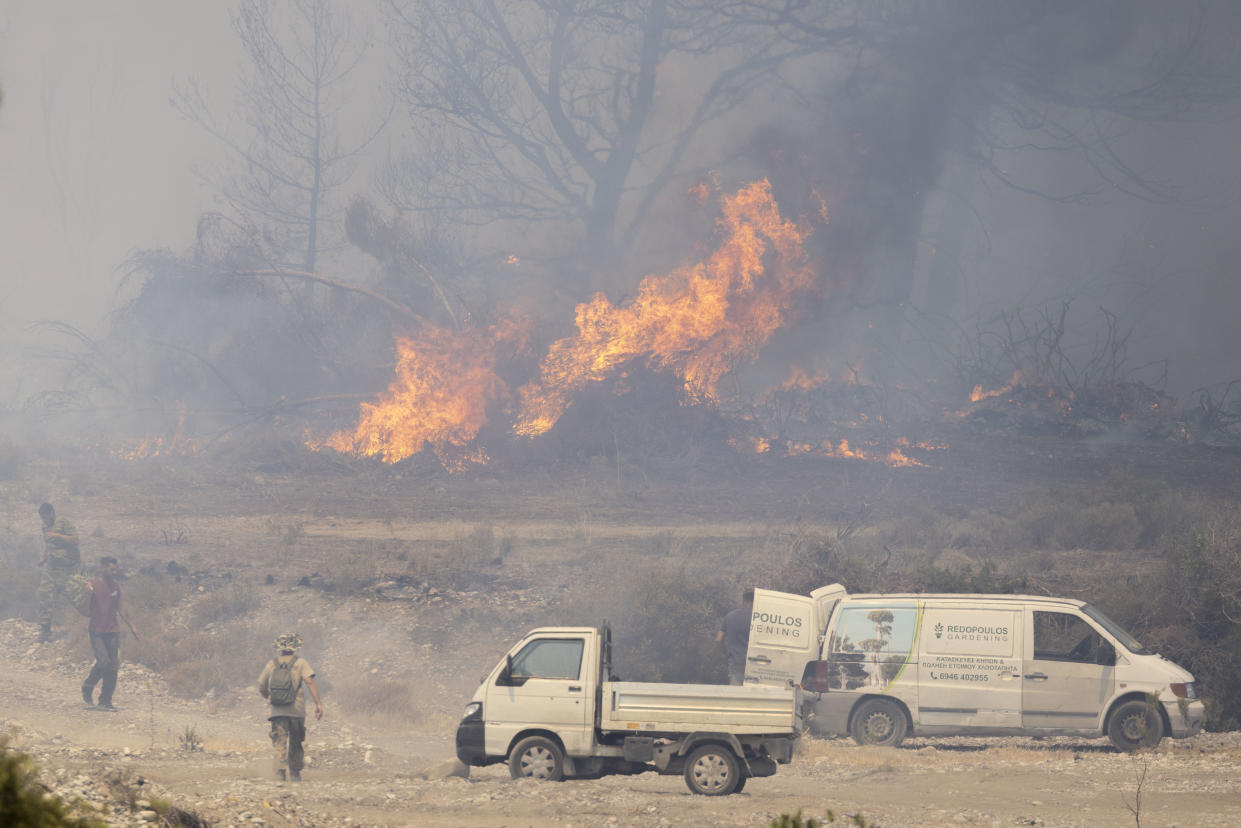 25 July 2023, Greece, -: Volunteers fight the many fires with the simplest of means, garden hoses and fire extinguishers are used. In Greece, forest fires are raging in numerous regions. Popular vacation resorts such as the islands of Rhodes and Corfu are also affected. Photo: Christoph Reichwein/dpa (Photo by Christoph Reichwein/picture alliance via Getty Images)