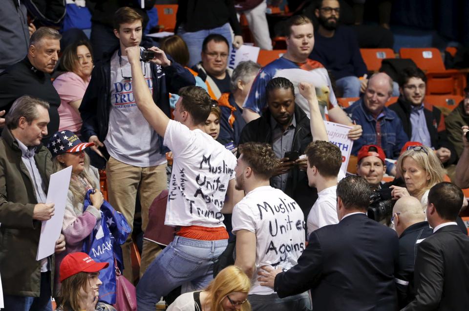 Protesters are escorted out of UIC Pavilion before Republican U.S. presidential candidate Donald Trump's rally at the University of Illinois at Chicago March 11, 2016. (REUTERS/Kamil Krzaczynski)