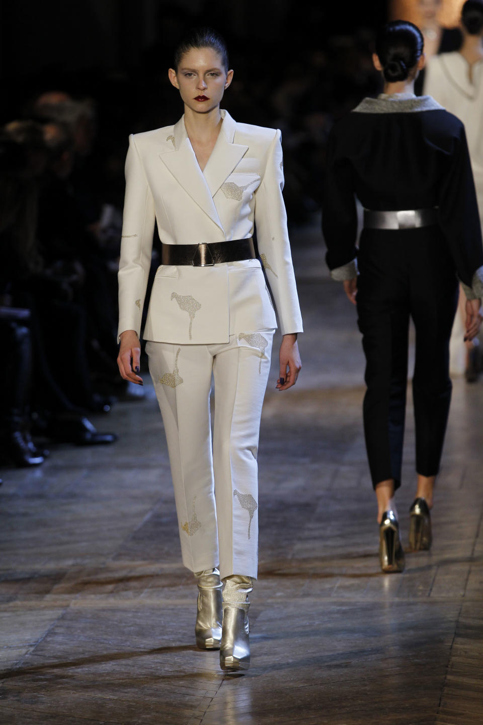 Models wear creations from Italian designer Stefano Pilati for Yves Saint Laurent as part of the Fall-Winter, ready-to-wear 2013 fashion collection, during Paris Fashion week, Monday, March 5, 2012. (AP Photo/Christophe Ena)