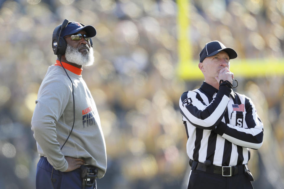 Illinois head coach Lovie Smith, left, watches a replay on the scoreboard during the second half of an NCAA college football game against Iowa, Saturday, Nov. 23, 2019, in Iowa City, Iowa. Iowa won 19-10. (AP Photo/Charlie Neibergall)