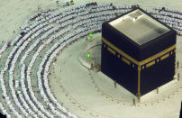 Muslim pilgrims pray shoulder to shoulder for the first time since the beginning of the coronavirus pandemic, in front of the Kaaba, the cubic building at the Grand Mosque, in the Muslim holy city of Mecca, Saudi Arabia, Sunday, Oct. 17, 2021. The Ministry of Interior announced Friday that, due to a significant nationwide decline in COVID-19 cases and the Kingdom's high vaccination rates, a number of restrictions will be relaxed starting Sunday. (AP Photo/Amr Nabil)