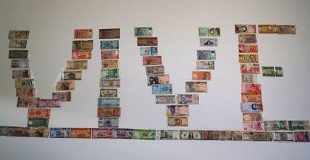 Paper money from countries around the world is posted at the reception desk for the Vive La Casa shelter for migrants in Buffalo, New York, U.S. July 5, 2017. Picture taken July 5, 2017. REUTERS/Chris Helgren