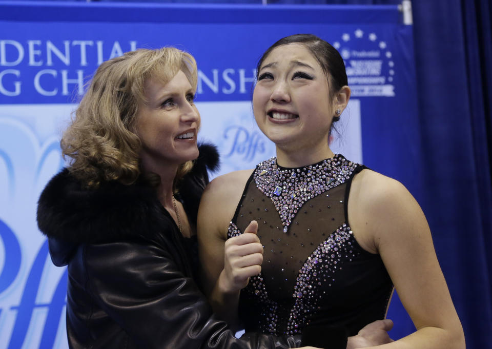 Mirai Nagasu, right, reacts to her scores as her coach Galina Barinova offers support during the women's free skate at the U.S. Figure Skating Championships Saturday, Jan. 11, 2014 in Boston. (AP Photo/Steven Senne)