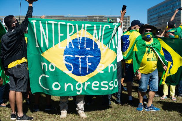 Supporters of Brazilian President Jair Bolsonaro hold a banner asking for military intervention during a protest amid the coronavirus (COVID-19) pandemic at the Esplanada dos Minsitérios on June 21, 2020, in Brasilia. (Photo: Andressa Anholete via Getty Images)