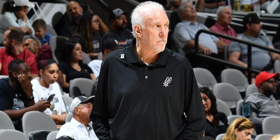 Gregg Popovich walks the sideline with his hands in his pockets during a Spurs preseason game in 2022.