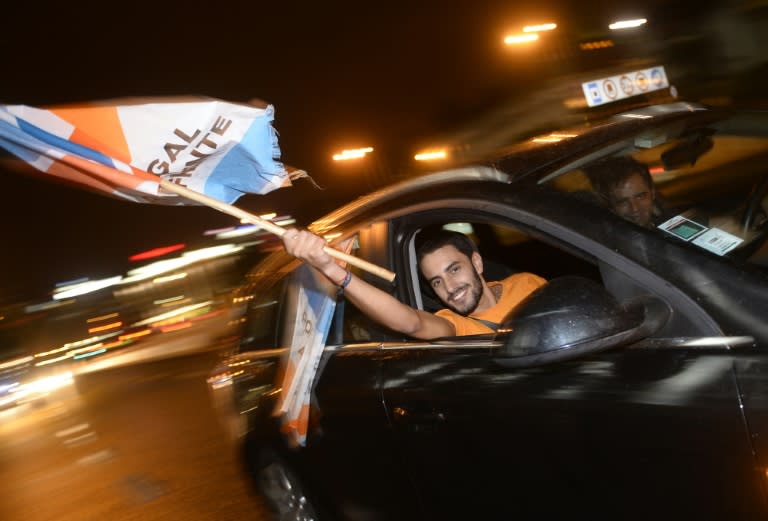 Supporters of Social Democratic Party wave flags as they celebrate after government elections in Lisbon, on October 4, 2015
