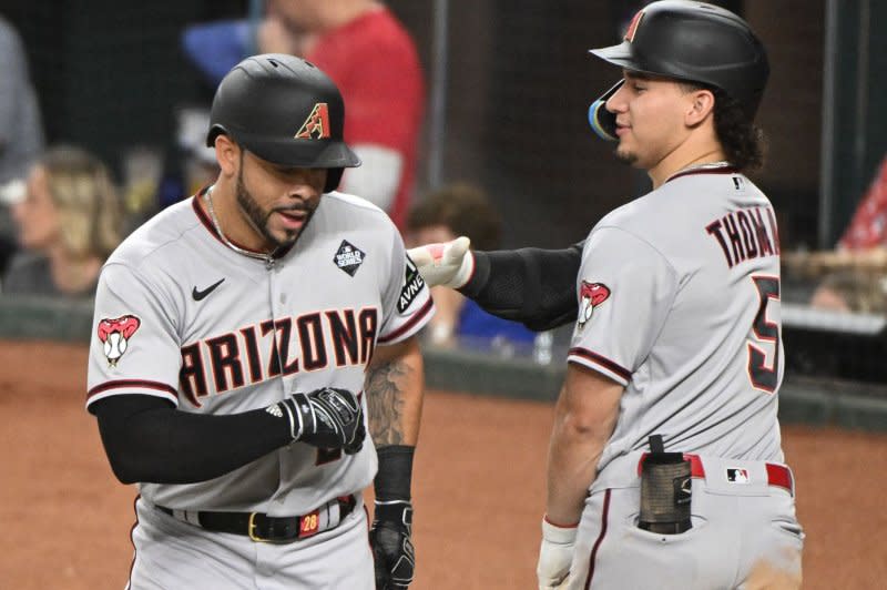 Arizona Diamondbacks designated hitter Tommy Pham (L) celebrates with outfielder Alek Thomas after scoring in the fourth inning against the Texas Rangers in Game 2 of the 2023 World Series on Saturday at Globe Life Field in Arlington, Texas. Photo by Ian Halperin/UPI