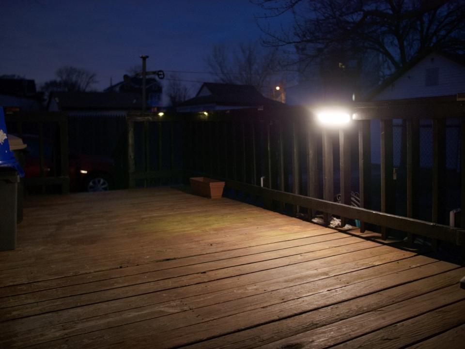 Ring Wall Light Solar light turned on at night to illuminate outdoor deck.