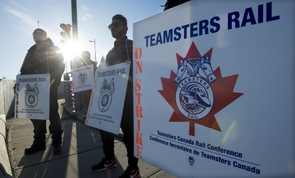 Striking CN rail members are seen outside the Mclean Rail Yard in North Vancouver., Wednesday, November, 20, 2019. (Jonathan Hayward/The Canadian Press via AP)