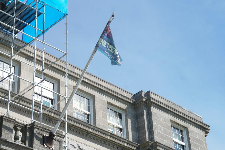 A Juneteenth flag flies atop City Hall in Newport during a celebration in 2020.