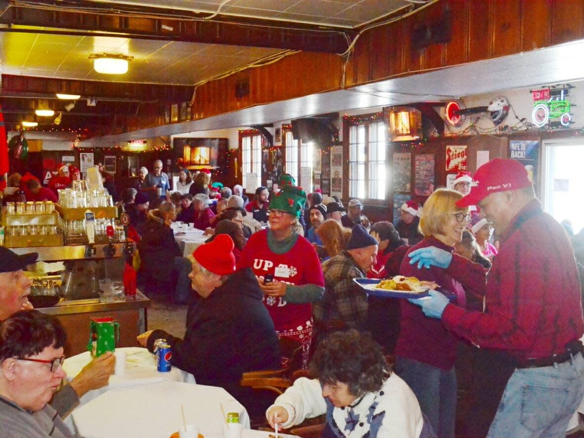 Diners enjoy a Christmas Day dinner at The Carleton Tavern in an undated photograph. The free annual tradition started in 2000.  (supplied by Cheryl Parrott - image credit)