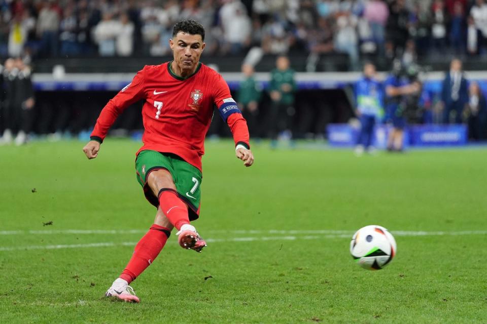 Cristiano Ronaldo scores in the penalty shoot-out against Slovenia (Bradley Collyer/PA) (PA Wire)