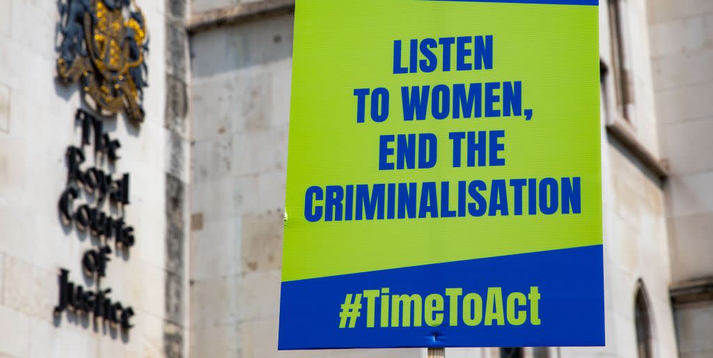 an abortion reform protest sign pictured outside of the royal courts of justice that reads listen to women, end the criminalisation