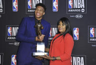 NBA player Giannis Antetokounmpo, of the Milwaukee Bucks, winner of the most valuable player award, left, and mother Veronica Antetokounmpo pose in the press room at the NBA Awards on Monday, June 24, 2019, at the Barker Hangar in Santa Monica, Calif. (Photo by Richard Shotwell/Invision/AP)