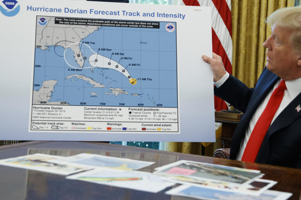 President Donald Trump holds a chart during a briefing on Hurricane Dorian in the White House, Sept. 4, 2019, in Washington. (AP Photo/Evan Vucci)