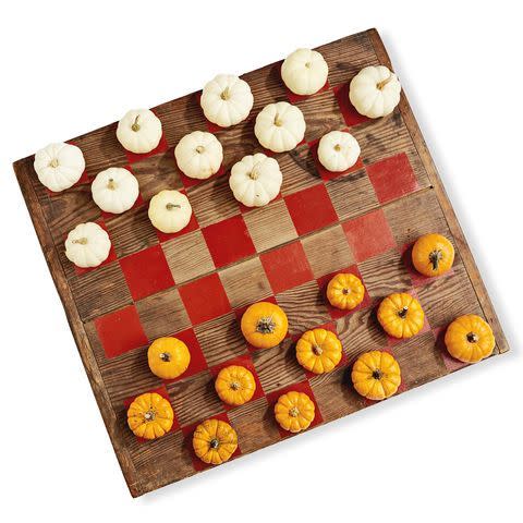 <p>Nothing beats sitting on the porch on a crisp autumn day while playing a round of checkers with a loved one or little one. Replace the usual game pieces with mini pumpkins for a decidedly fun fall touch.</p>