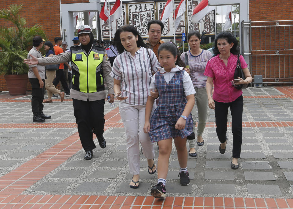 Relatives of passengers arrive at Lion Air's crisis center at Soekarno-Hatta International Airport in Tangerang, Indonesia Monday, Oct. 29, 2018. A Lion Air flight crashed into the sea just minutes after taking off from Indonesia's capital on Monday in a blow to the country's aviation safety record after the lifting of bans on its airlines by the European Union and U.S. (AP Photo/Tatan Syuflana)