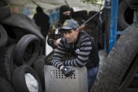 Pro-Russian activists guard barricades in Slovyansk, Ukraine, Saturday, April 19, 2014. Pro-Russian insurgents defiantly refused Friday to surrender their weapons or give up government buildings in eastern Ukraine, despite a diplomatic accord reached in Geneva and overtures from the government in Kiev.(AP Photo/Alexander Zemlianichenko)