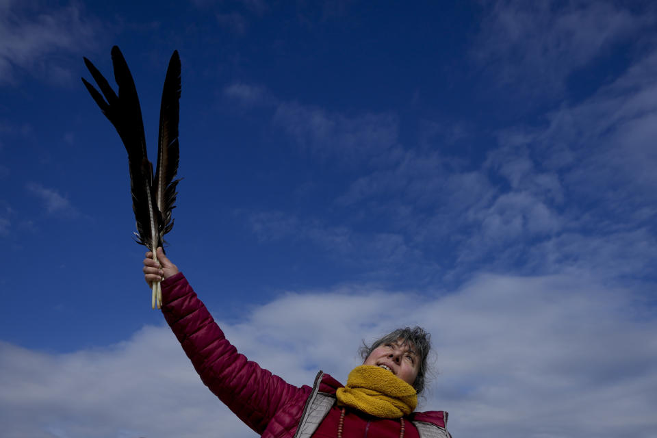 Monica Marracino holds Condor feathers while performing a spiritual dance near the Uritorco mountain in Capilla del Monte, Cordoba, Argentina, Tuesday, July 18, 2023. In the pope’s homeland of Argentina, Catholics have been renouncing the faith and joining the growing ranks of the religiously unaffiliated. Commonly known as the “nones,” they describe themselves as atheists, agnostics, spiritual but not religious, or simply: “nothing in particular.” (AP Photo/Natacha Pisarenko)