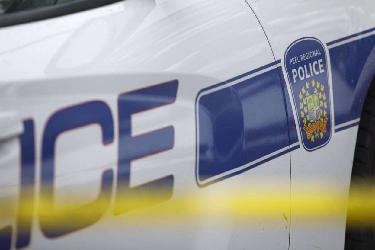 Peel Regional Police work the scene around a home in Brampton, Ont., on November 7, 2019. THE CANADIAN PRESS/Cole Burston