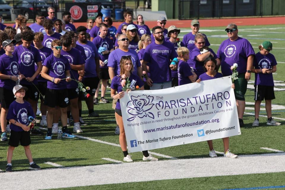 Participants gather on the football field participated at the Tournament of Roses Parade Charity Walk at St. Joseph High School on July 19, 2022