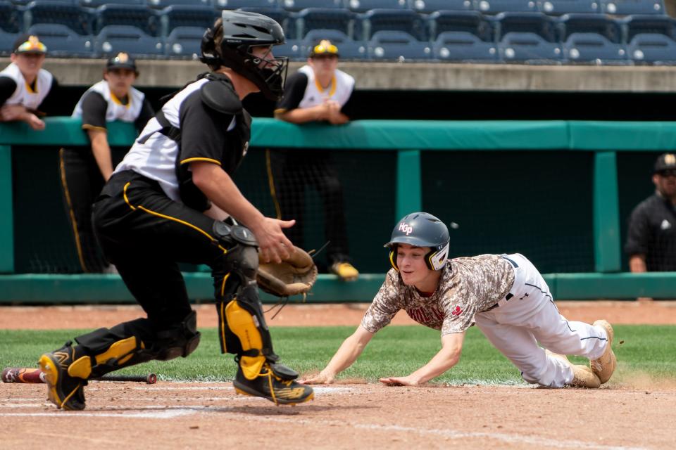 Holy Ghost Prep designated runner Noah McDermott slides home with a run as Montour's Matthew Luchovick awaits the throw during the 2022 PIAA Class 4A state championship game.
