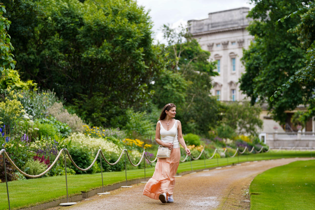 A visitor enjoys the garden during a preview of the Garden at Buckingham Palace, Queen Elizabeth II's official residence in London, which opens to members of the public on Friday. Visitors will be able to picnic in the garden and explore the open space for the first time. Picture date: Thursday July 8, 2021. (Photo by Kirsty O'Connor/PA Images via Getty Images)