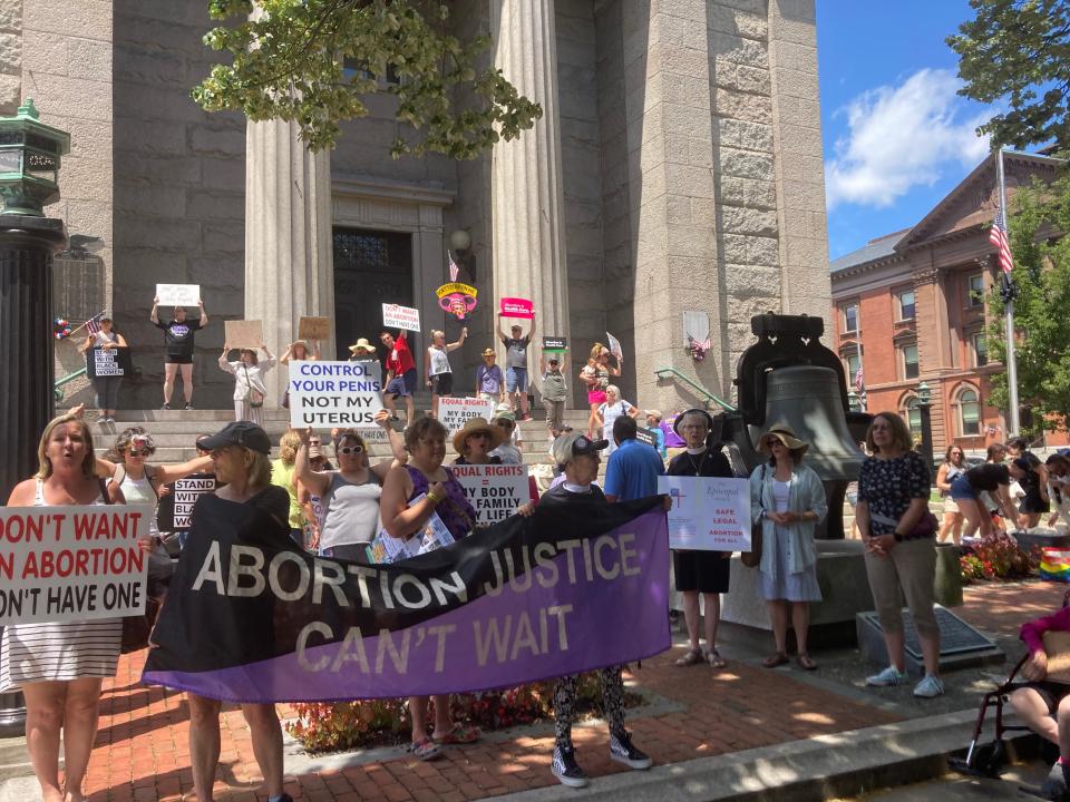 Demonstrators gather on the steps of the New Bedford Public Library on Saturday, July 9. The demonstration, organized by the Women's Alliance of Southeastern Massachusetts, was against the recent Supreme Court decision to overturn Roe v. Wade.