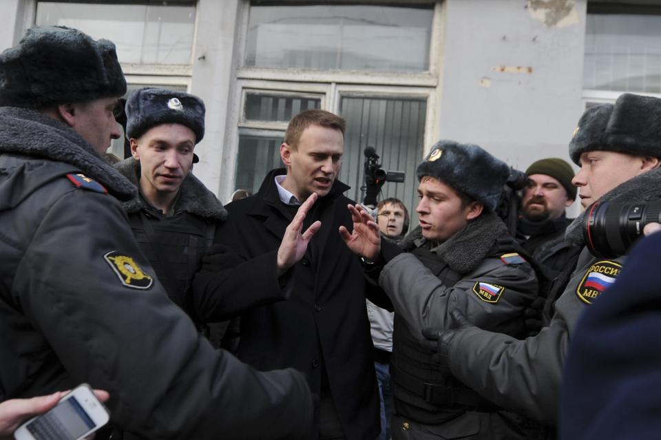 Opposition leader Alexei Navalny, center, is detained by police in Moscow, Saturday Oct. 27, 2012. Opposition leaders and activists held a one-man picket against torture in Russia. (AP Photo/Sergey Ponomarev)