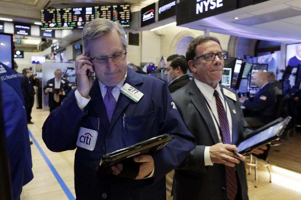 Traders Christopher Fuchs, left, and Sal Suarino work on the floor of the New York Stock Exchange, Tuesday, Jan. 17, 2017. Stocks are opening slightly lower on Wall Street, led by declines in banks and health care companies. (AP Photo/Richard Drew)