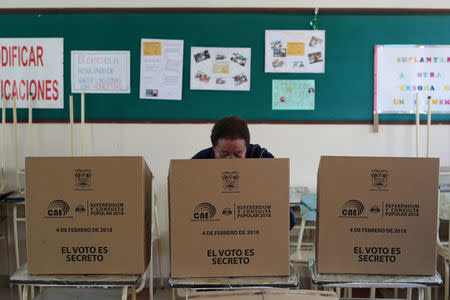 A woman casts her vote in a referendum on whether to prevent unlimited presidential re-election, in Quito, Ecuador February 4, 2018. REUTERS/Daniel Tapia