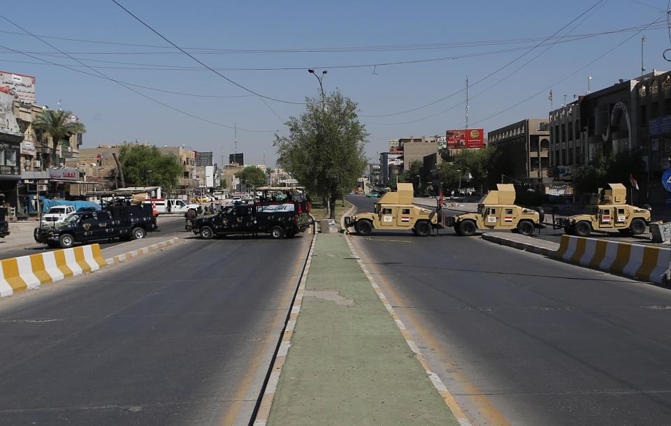 Iraqi security forces close the streets while Iraqi Popular Mobilization Forces march during "al-Quds" Day, Arabic for Jerusalem, in Baghdad, Iraq, Friday, May 31, 2019. Jerusalem Day began after the 1979 Islamic Revolution in Iran when the Ayatollah Khomeini declared the last Friday of the Muslim holy month of Ramadan a day to demonstrate the importance of Jerusalem to Muslims. (AP Photo/Khalid Mohammed)