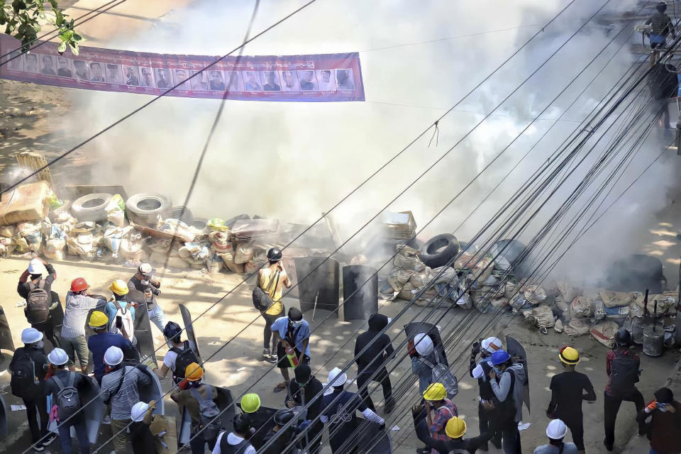 Anti-coup protesters maintain their position behind a barricade despite smoke from tear gas in San Chaung township in Yangon, Myanmar Friday, Mar. 5, 2021. Demonstrators defy growing violence by security forces and stage more anti-coup protests ahead of a special U.N. Security Council meeting on the country’s political crisis. (AP Photo)