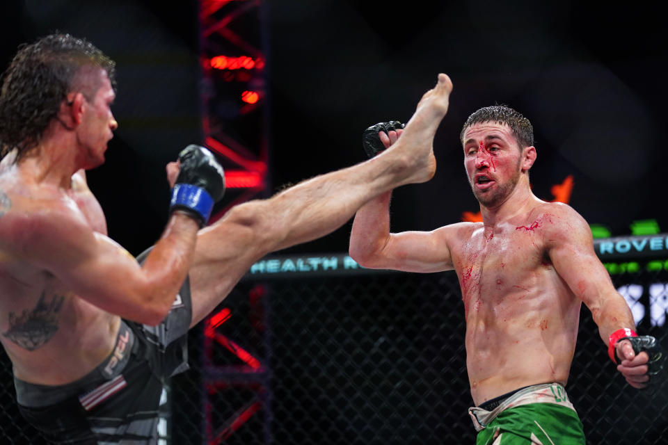 Brendan Loughnane, right, doges a kick by Tyler Diamond during a Professional Fighters League mixed martial arts bout in Atlantic City, N.J., Thursday, June 10, 2021. (AP Photo/Matt Rourke)