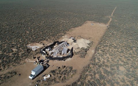 An aerial view of a makeshift compound is seen in the desert area of Amalia - Credit:  Brian Skoloff/AP