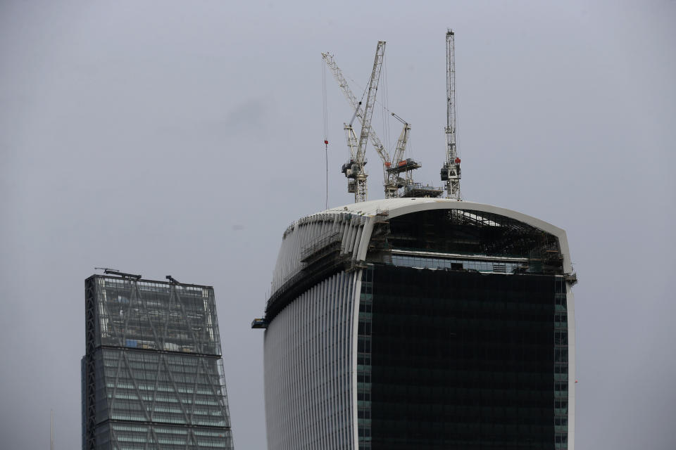 In this photo taken Friday Jan. 24, 2014, construction cranes work on a building in London. The face of London is about to change. Dozens of buildings of 20 stories or more are slated for construction, many to be clustered along the south bank of the River Thames just down the river from Big Ben and the majestic dome of St. Paul’s Cathedral. (AP Photo/Sang Tan)