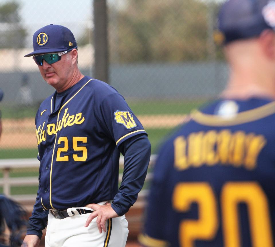 Brewers minor-league instructor Charlie Greene watches closely during catching drills during workouts Monday.