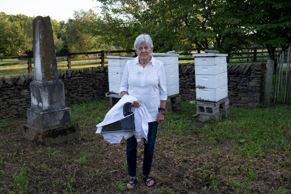 Jane Thomas, 87, stands in her family cemetery in Leesburg, Kentucky. In honor of her grandfather, Thomas keeps honeybees in the cemetery. 
Aug. 11, 2022