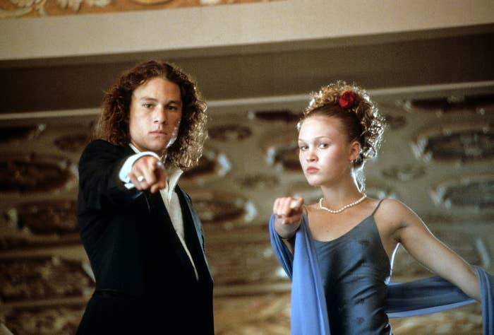 Heath Ledger and Julia Stiles in prom clothes point down at the camera