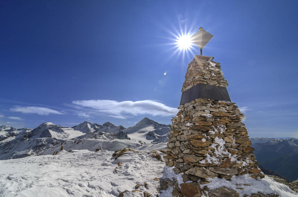 In this photo provided by the South Tyrol Museum of Archaeology, a memorial stands at the site where "Oetzi the Iceman" was found in the Italian Alps. Decades after he was discovered, scientists determined that Oetzi was mostly descended from farmers from present day Turkey, and his head was balder and skin darker than what was initially thought, according to a study published Wednesday, Aug. 16, 2023, in the journal Cell Genomics. (Dario Frasson/South Tyrol Museum of Archaeology via AP)