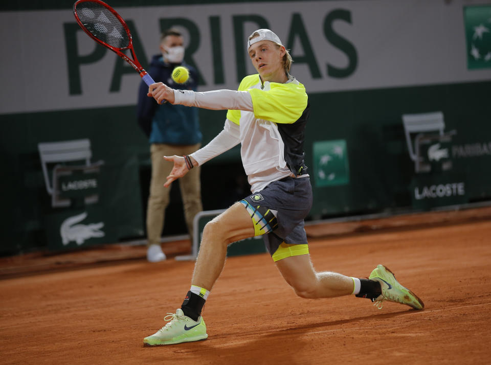 Canada's Denis Shapovalov plays a shot against France's Gilles Simon in the first round match of the French Open tennis tournament at the Roland Garros stadium in Paris, France, Tuesday, Sept. 29, 2020. (AP Photo/Michel Euler)