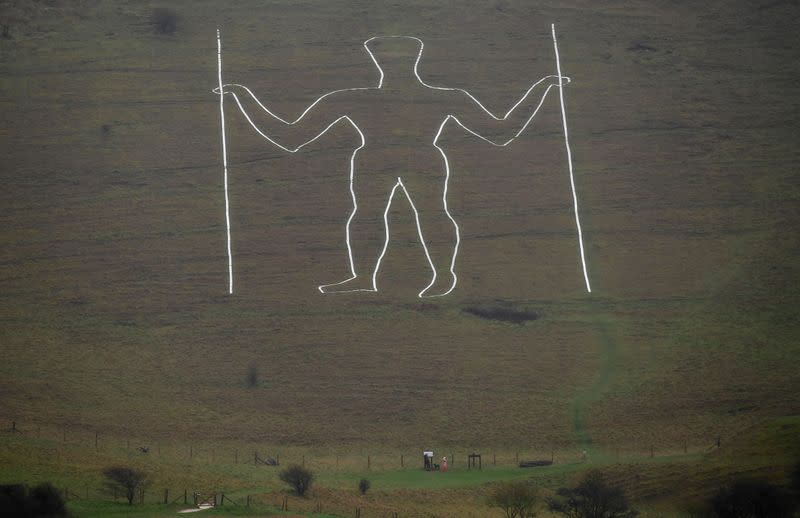 Long Man of Wilmington hill figure restored, following an alteration depicting a mask, in South Downs national park, near Eastbourne