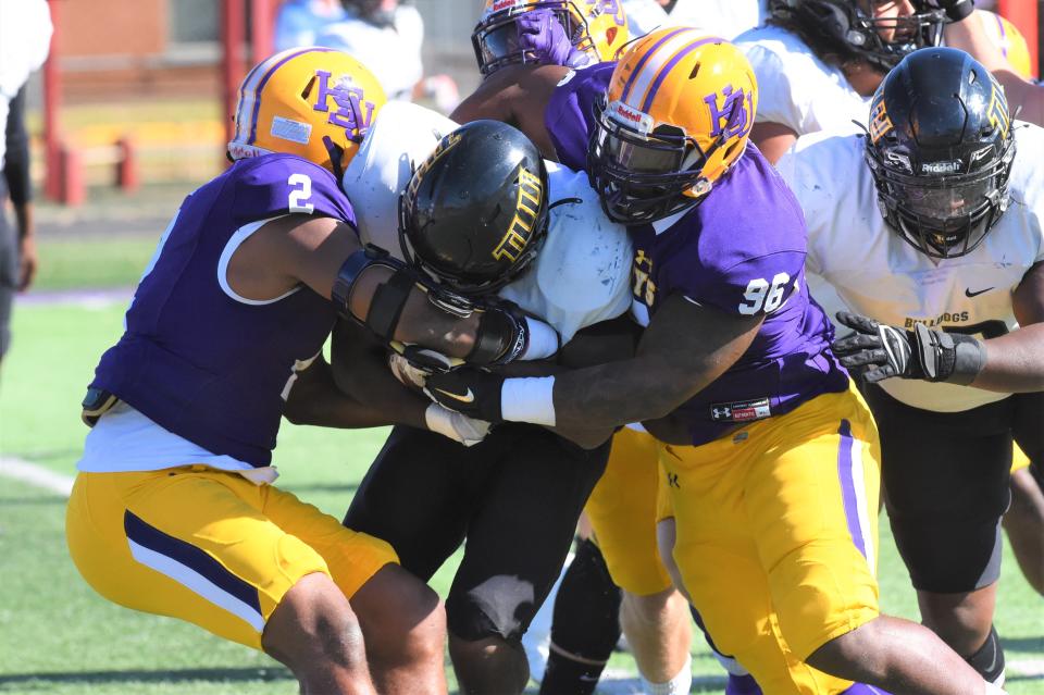 Hardin-Simmons linebacker Terrell Franklin (2) and Khristion Little (96) combine to make a tackle during last year's regular season finale against Texas Lutheran at Shelton Stadium.