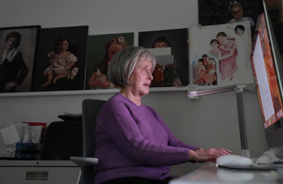 A woman sits in her writing room at her Los Angeles home.