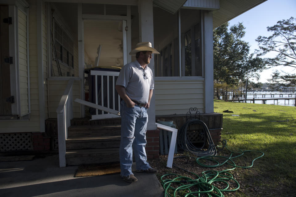 Lucas Simon surveys the damage to his house along Lake Arthur the day after Hurricane Delta on Saturday, Oct. 10, 2020. Simon, who is a crawfish, soybean, rice, and cattle farmer said he lost three cows because of mosquitoes following Hurricane Laura. (Chris Granger/The Advocate via AP)