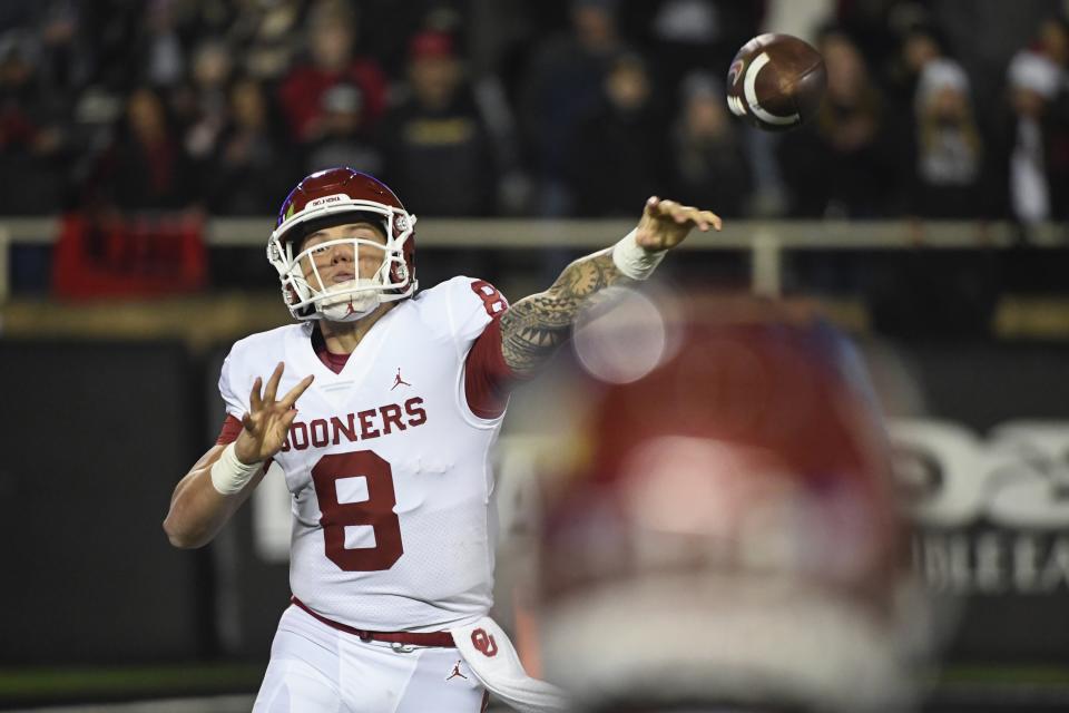 Oklahoma quarterback Dillon Gabriel (8) throws a pass to wide receiver Drake Stoops during the first half of an NCAA college football game against Texas Tech on Saturday, Nov. 26, 2022, in Lubbock, Texas. (AP Photo/Justin Rex)