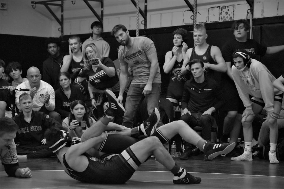 Wellington wrestling coach Travis Gray (center) watches wrestlers compete in region final duals hosted at Olympic Heights in Boca Raton on Jan. 12, 2023.